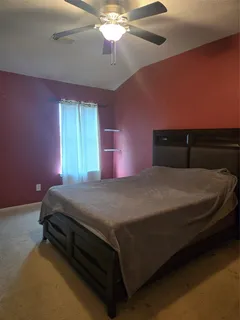 a bed sitting in a room next to a window