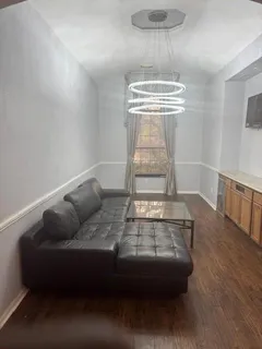 a living room with furniture and a hard wood floor