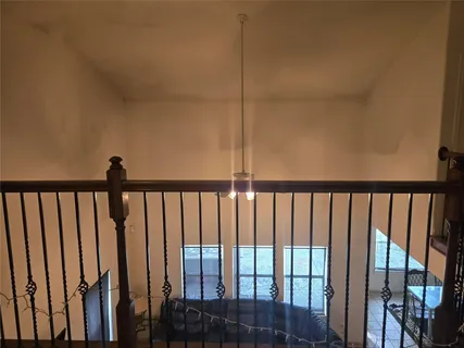 a view of staircase with rug