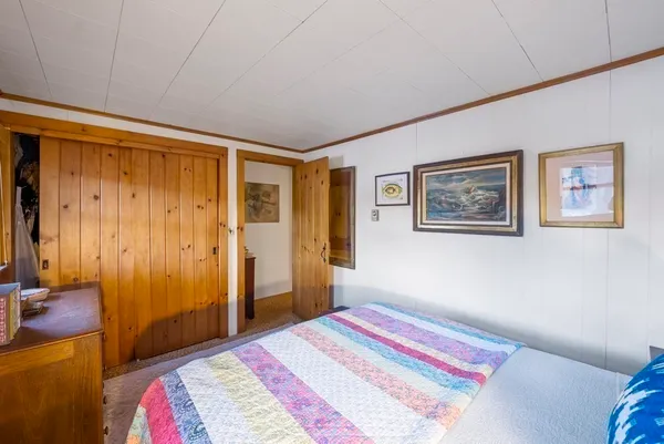 a spacious bedroom with two beds and a window