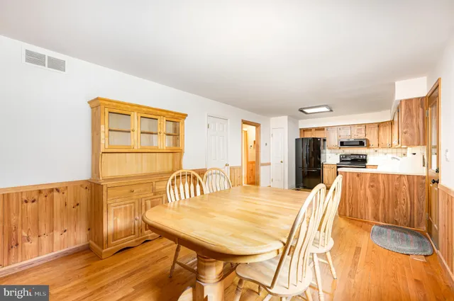 a dining room with furniture and wooden floor