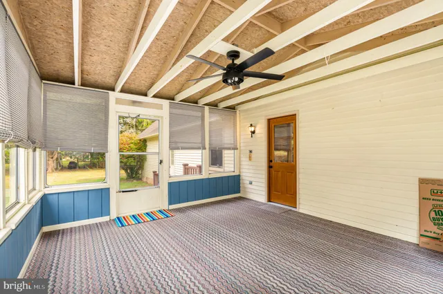 a room with wooden floor and windows