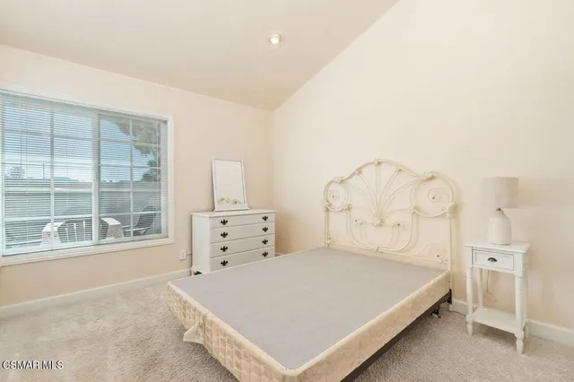 a large white bed in a white room