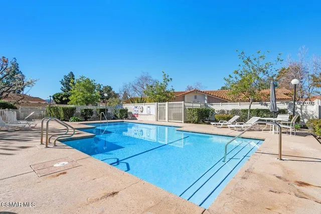 a view of a swimming pool with a lounge chairs