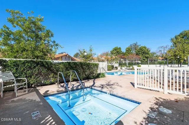 a view of a swimming pool with a patio and a garden