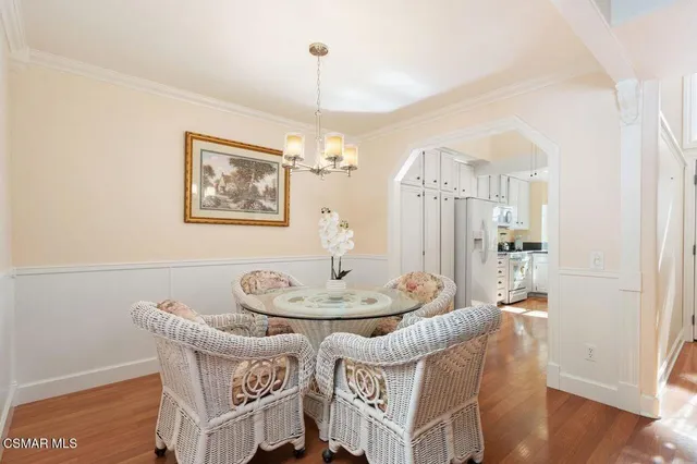 a dining room with furniture and wooden floor