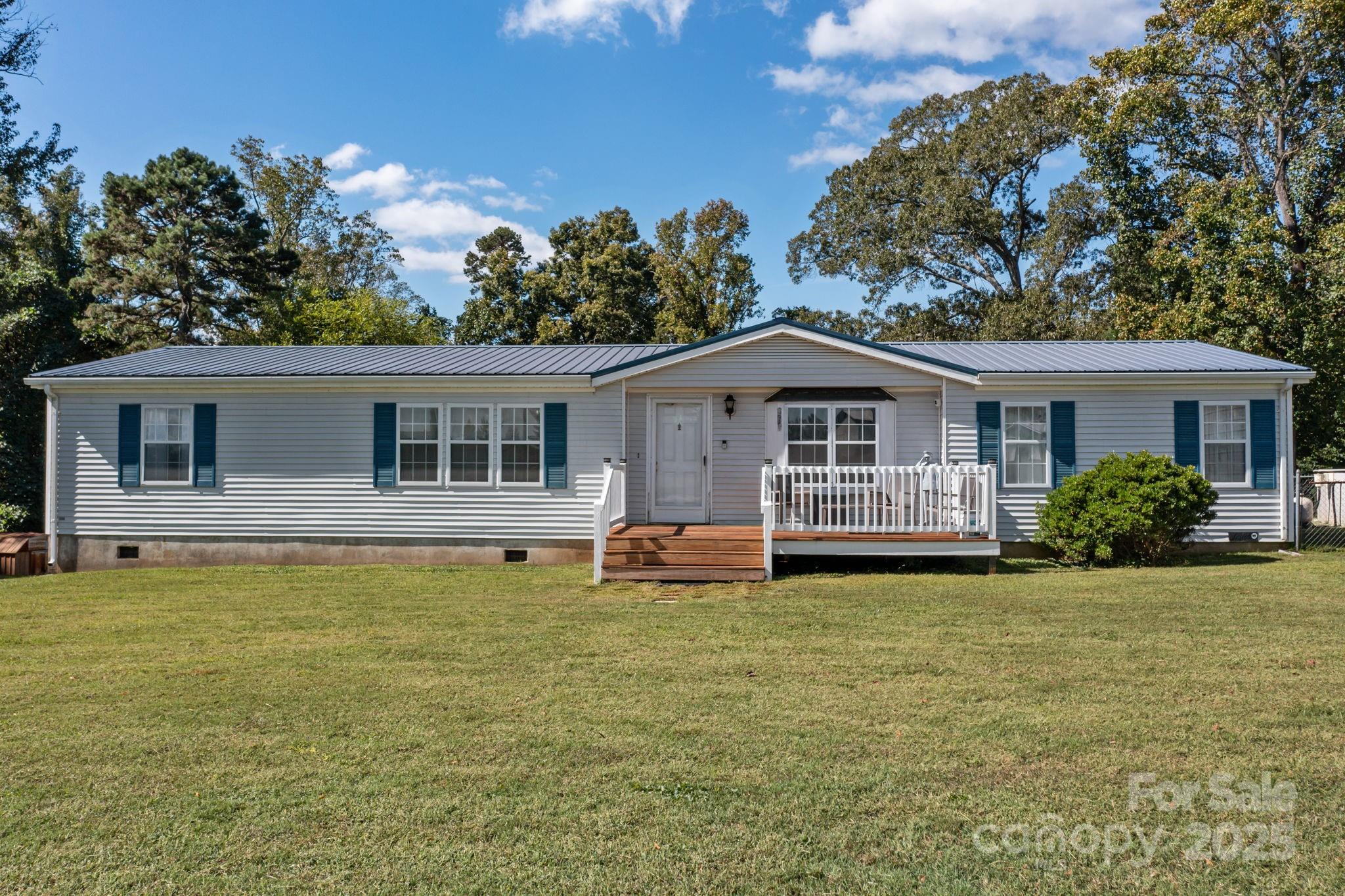 a front view of a house with a garden and porch