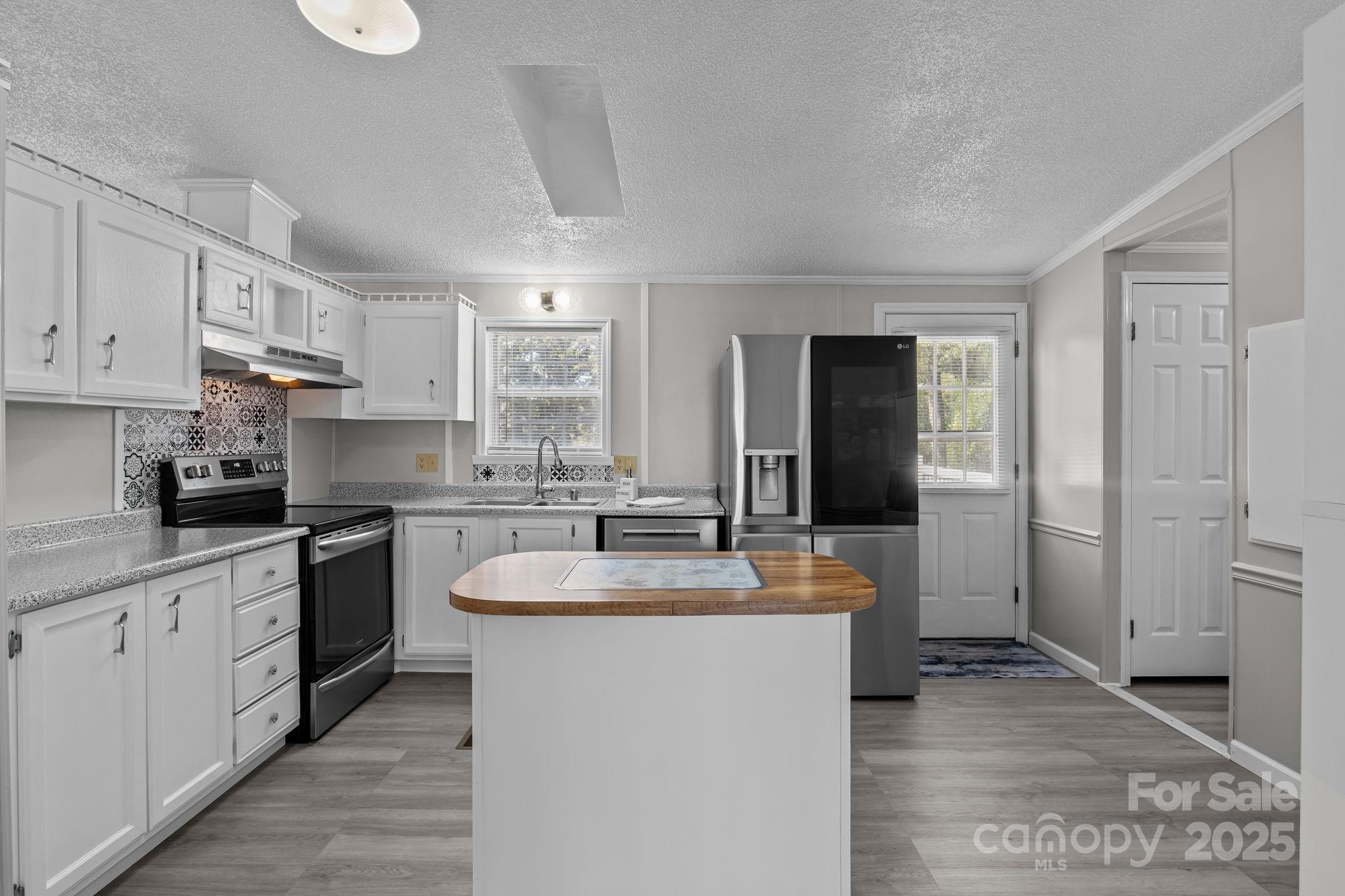 555 Fairmount Road Statesville, NC 28625 - Photo 13 of 48 a large kitchen with kitchen island a sink stainless steel appliances and cabinets