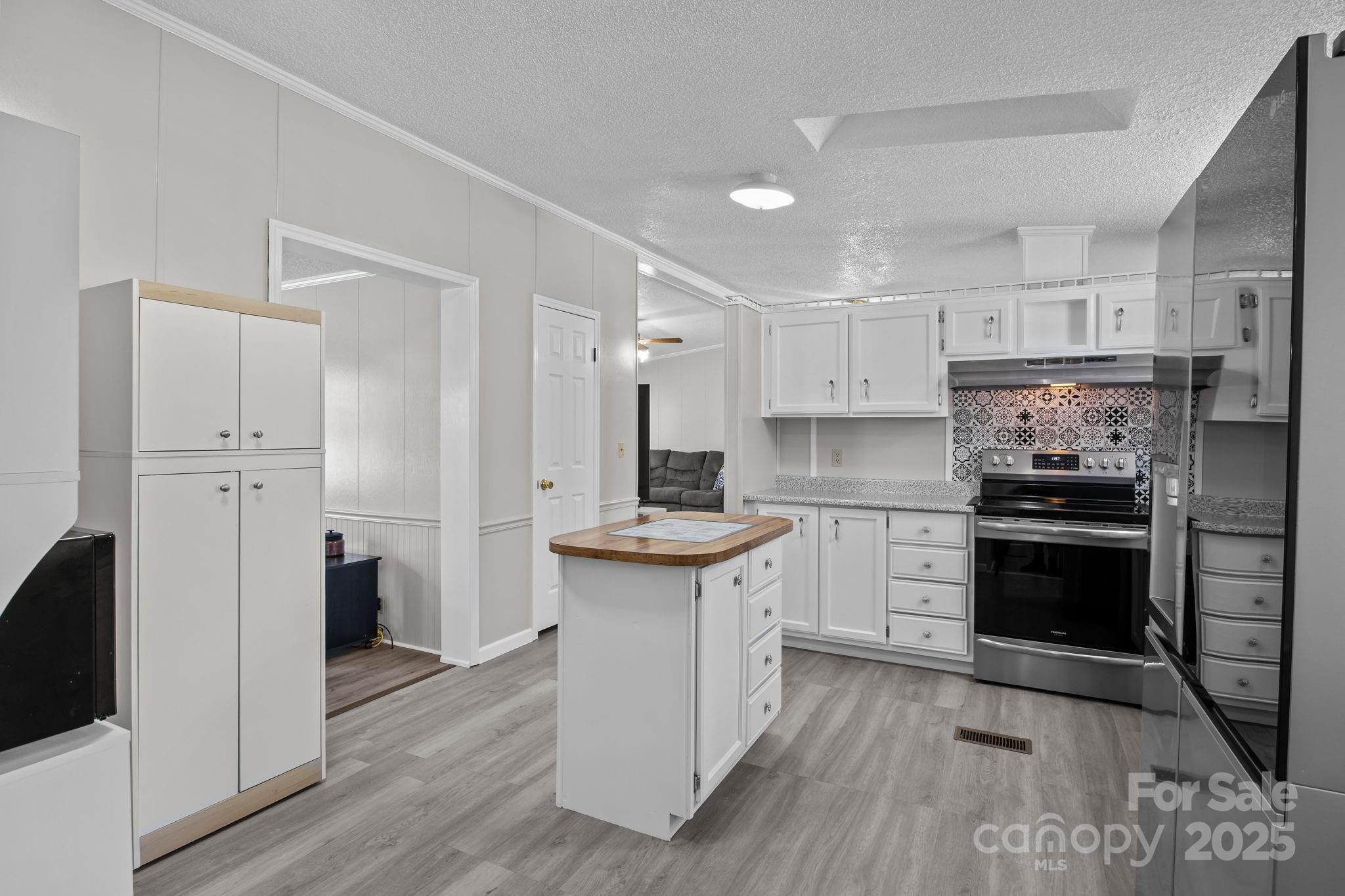 555 Fairmount Road Statesville, NC 28625 - Photo 15 of 48 a kitchen with cabinets and stainless steel appliances