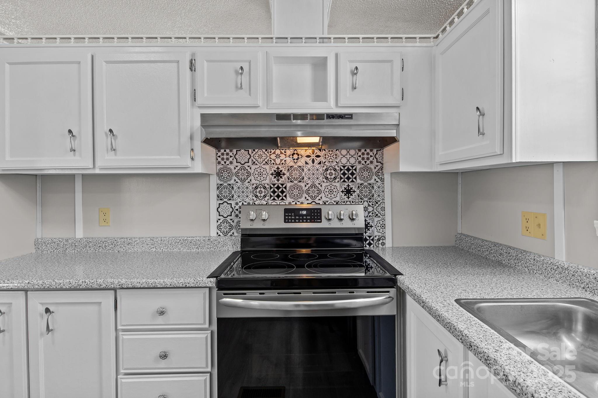 555 Fairmount Road Statesville, NC 28625 - Photo 19 of 48 a stove top oven sitting inside of a kitchen