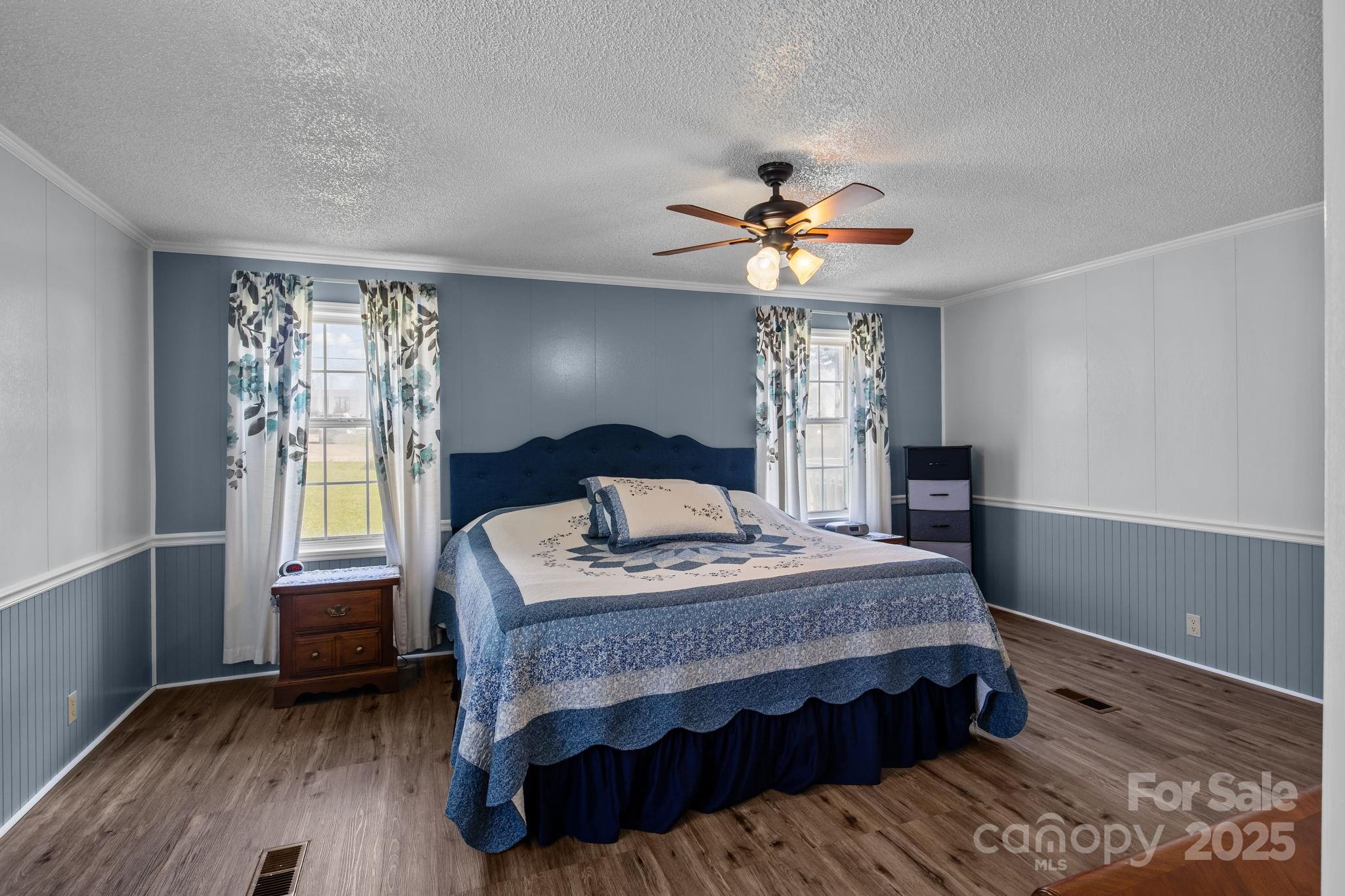 555 Fairmount Road Statesville, NC 28625 - Photo 24 of 48 a bedroom with a bed a chandelier and a window