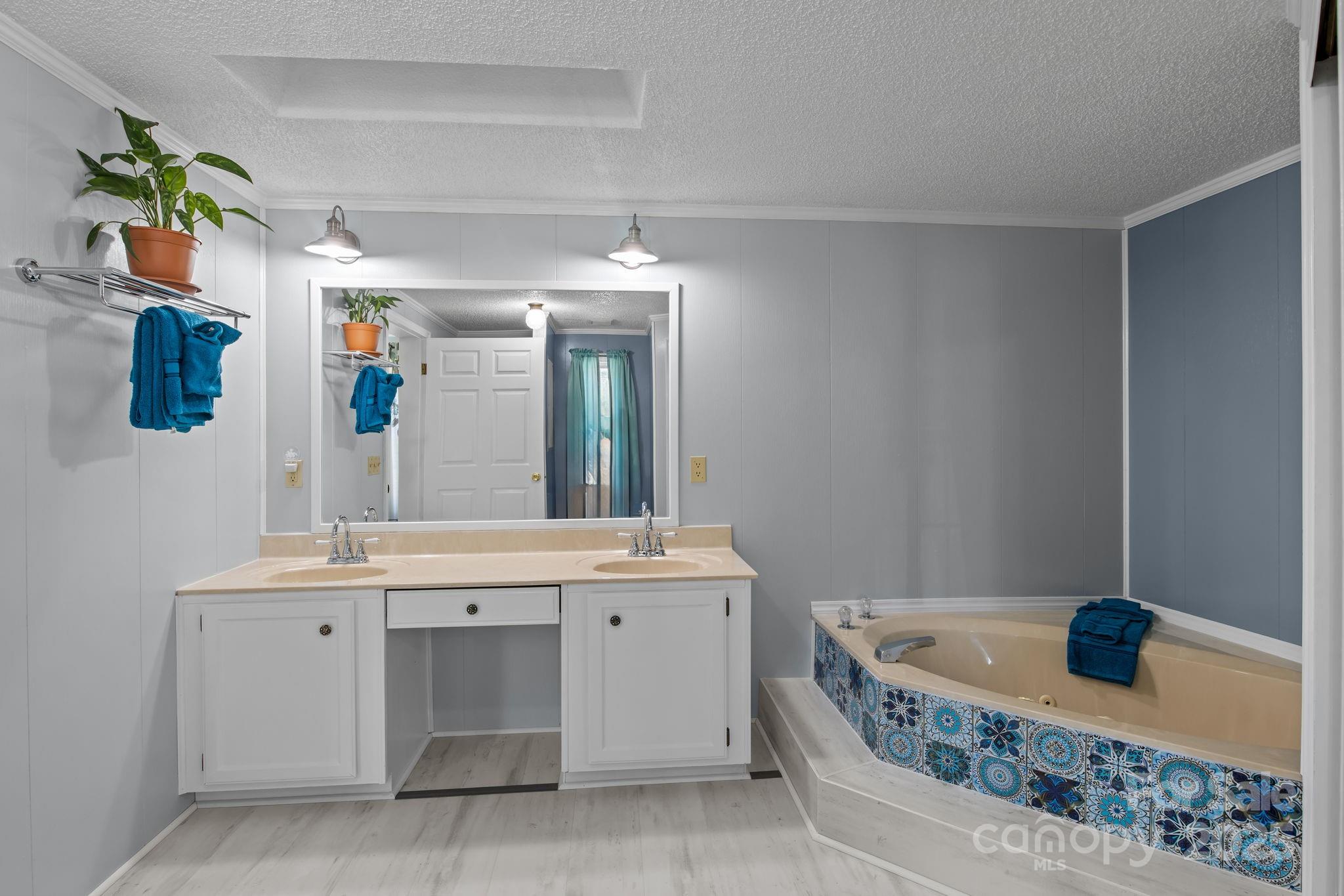 555 Fairmount Road Statesville, NC 28625 - Photo 26 of 48 a spacious bathroom with a granite countertop sink and mirror