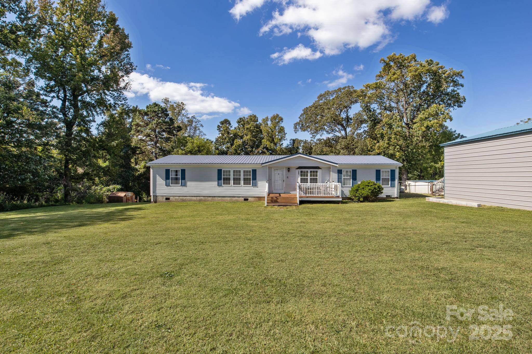 555 Fairmount Road Statesville, NC 28625 - Photo 3 of 48 a front view of a house with a garden