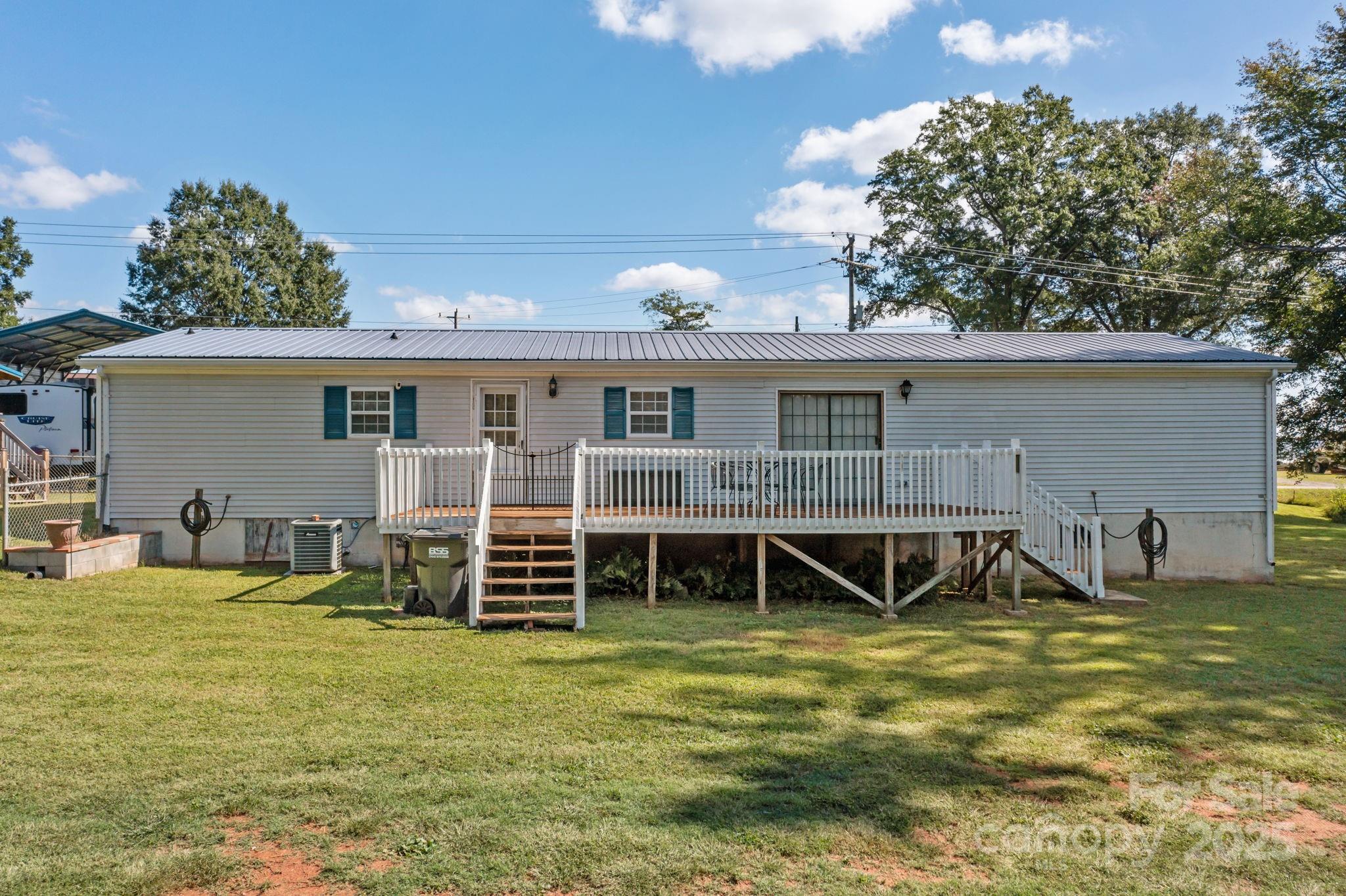 555 Fairmount Road Statesville, NC 28625 - Photo 32 of 48 a view of a house with backyard porch and sitting area