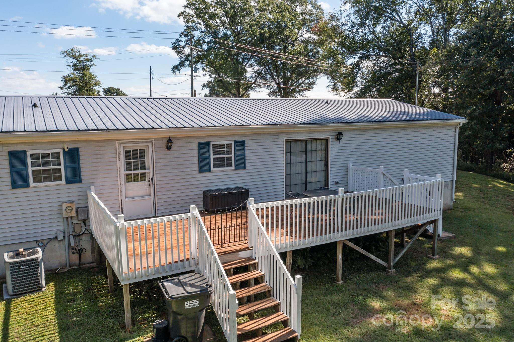 555 Fairmount Road Statesville, NC 28625 - Photo 33 of 48 a view of a patio with table and chairs with wooden floor and fence