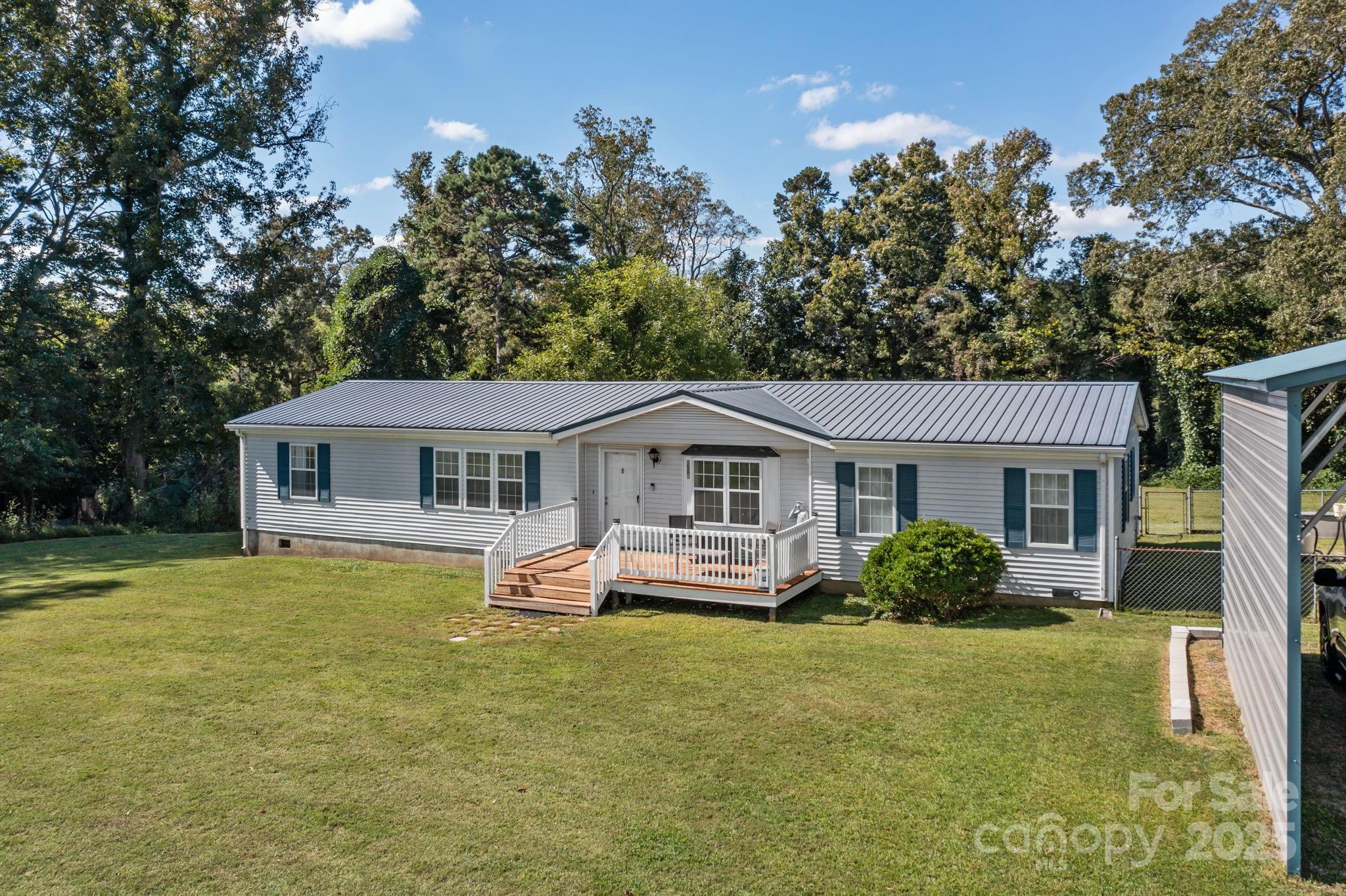 555 Fairmount Road Statesville, NC 28625 - Photo 40 of 48 a front view of a house with a garden and trees