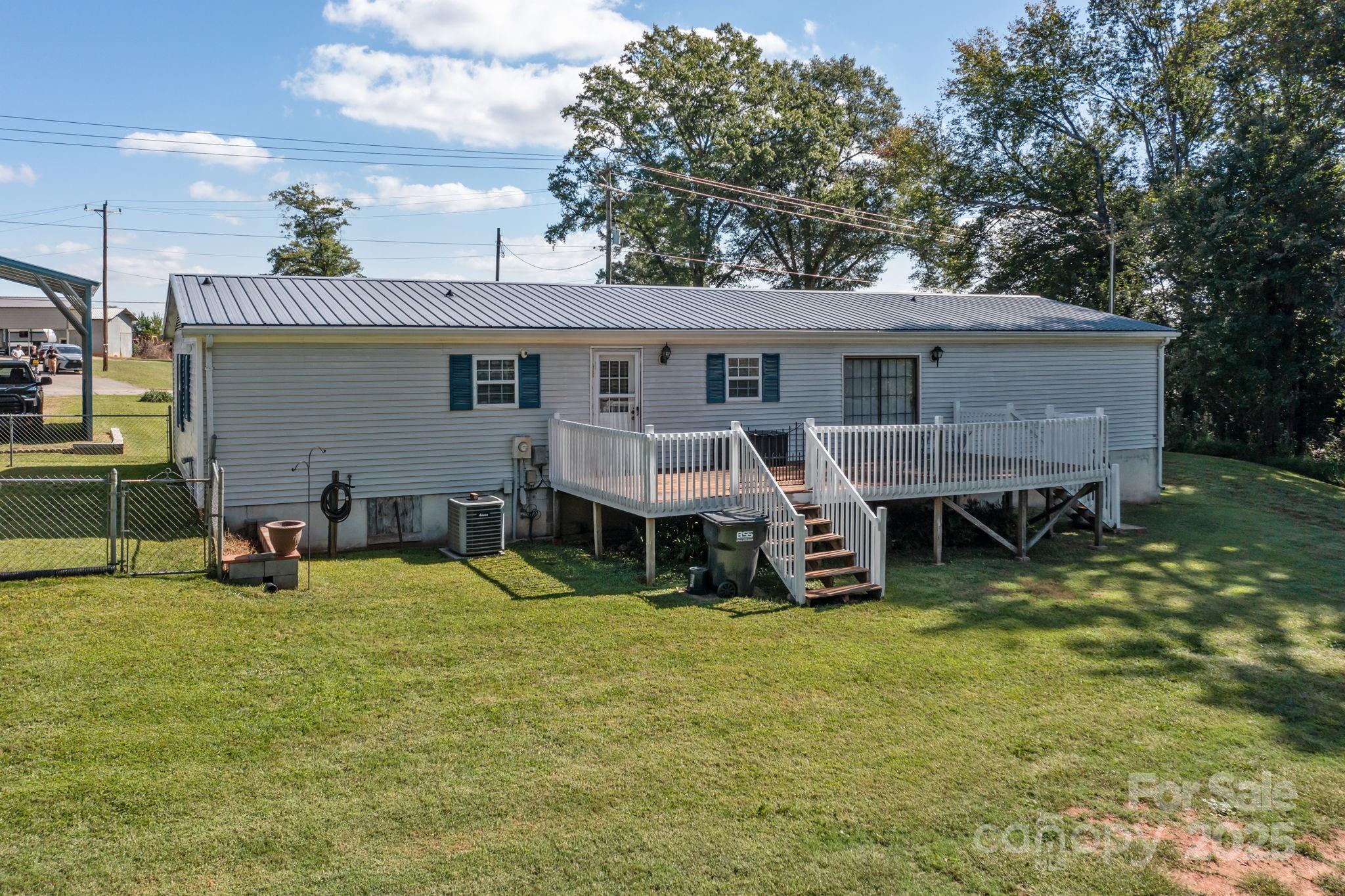 555 Fairmount Road Statesville, NC 28625 - Photo 42 of 48 a view of a house with a yard and sitting area