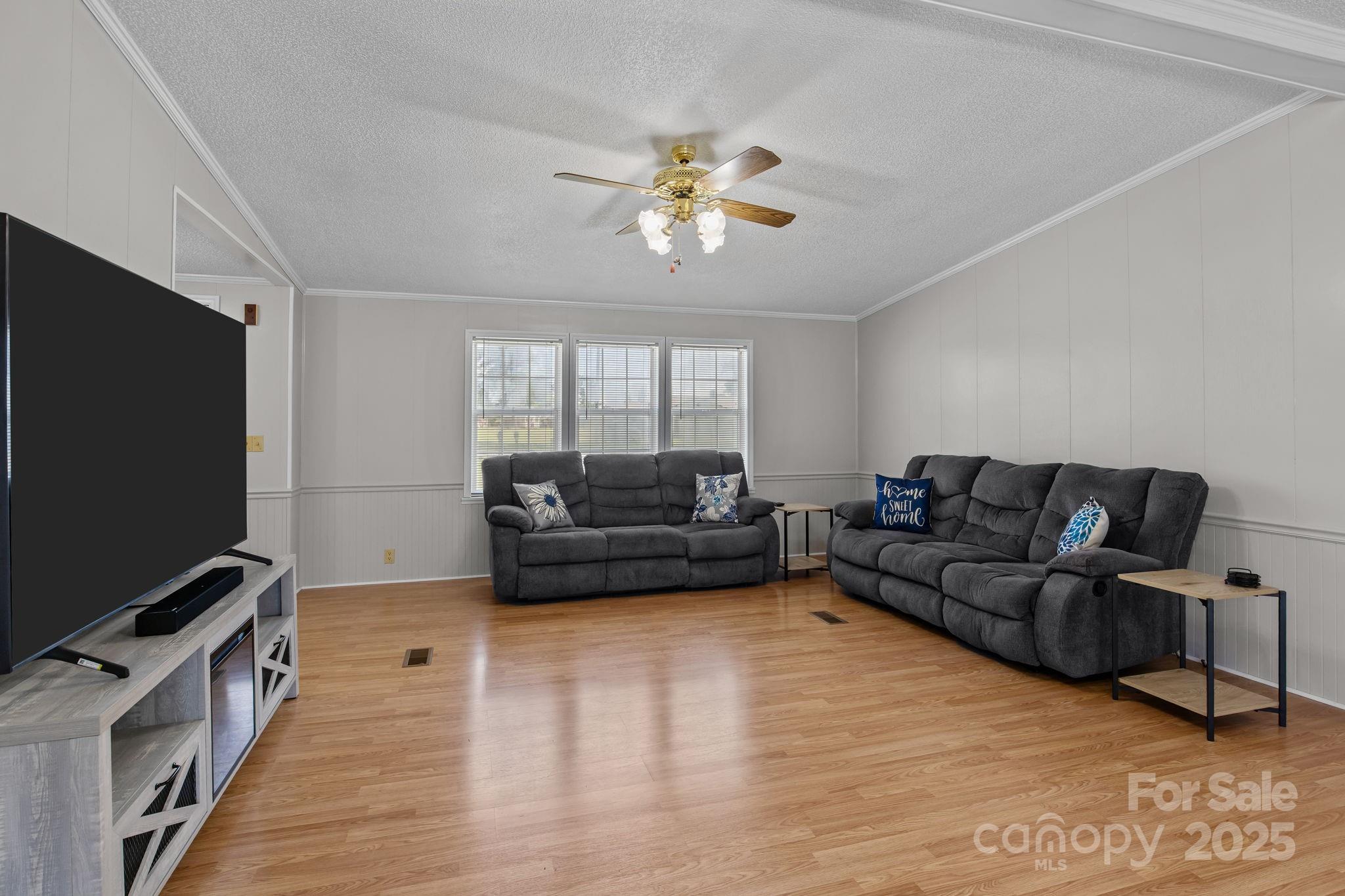 555 Fairmount Road Statesville, NC 28625 - Photo 10 of 48 a living room with furniture and a flat screen tv