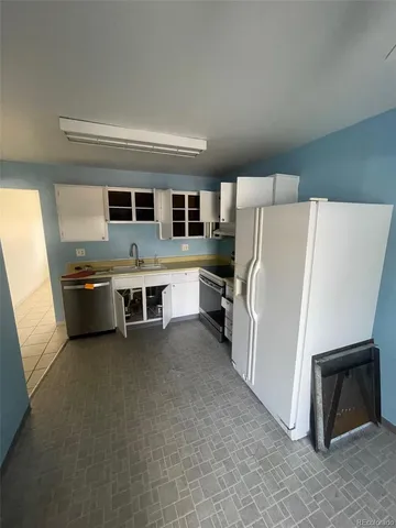 a kitchen with stainless steel appliances a stove a microwave and a refrigerator