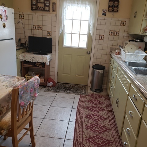 2724 West Gregory Street, Unit 2 Chicago, IL 60625 - Photo 11 of 15 a kitchen with a sink a stove and a microwave