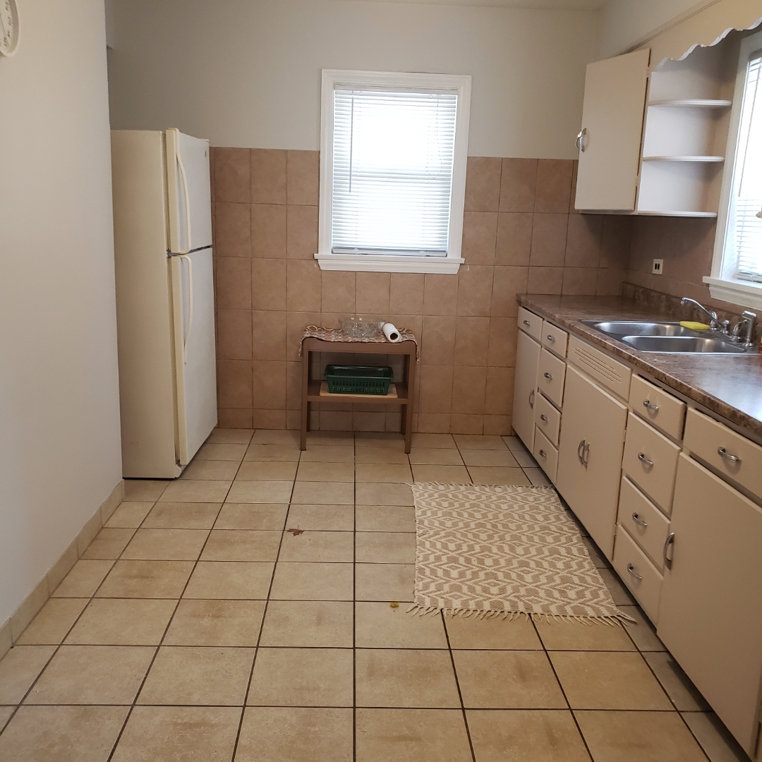 2724 West Gregory Street, Unit 2 Chicago, IL 60625 - Photo 9 of 15 a kitchen with stainless steel appliances granite countertop a stove a sink and a refrigerator