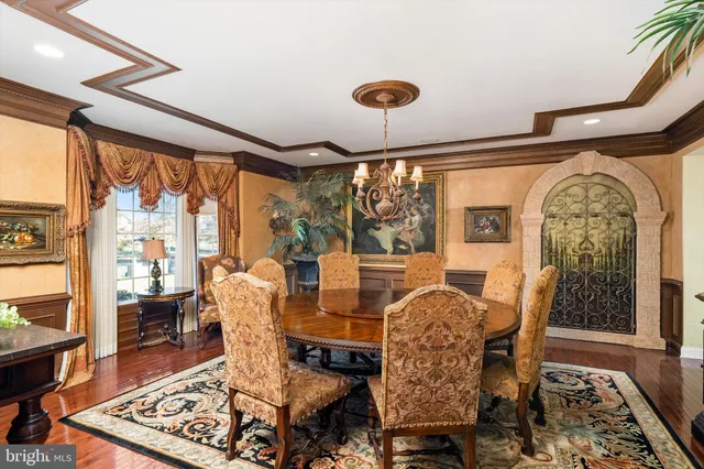 a living room with furniture a fireplace and a chandelier