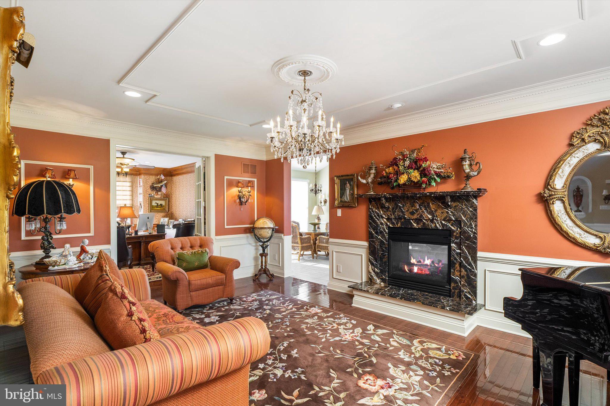 30 Ridgeview Way Allentown, NJ 08501 - Photo 13 of 57 a living room with furniture a fireplace and a chandelier