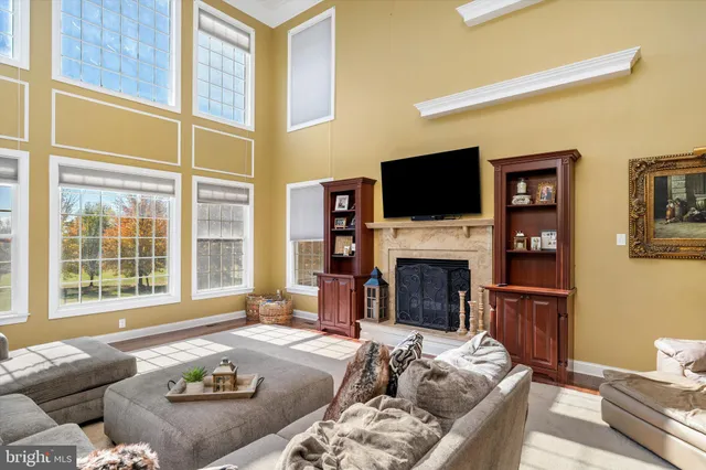 a living room with furniture flat screen tv and a large window