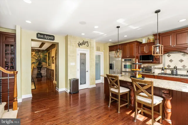 a view of a dining room with furniture wooden floor and a chandelier