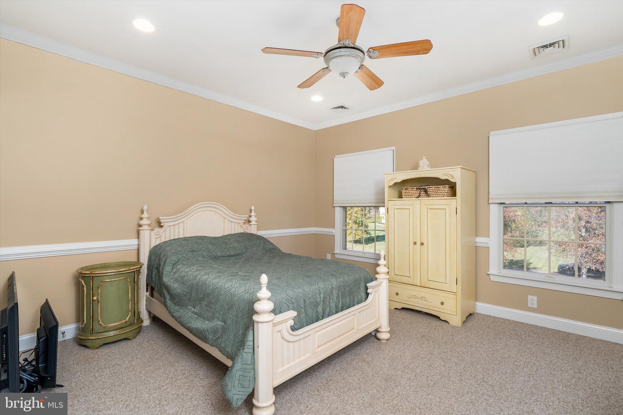30 Ridgeview Way Allentown, NJ 08501 - Photo 36 of 57 a bedroom with a bed and a chandelier