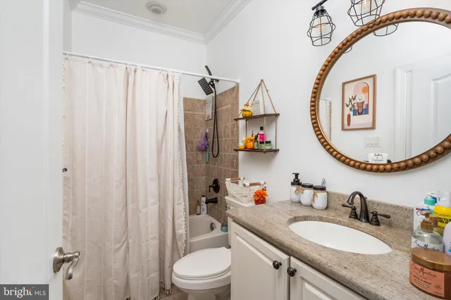 a bathroom with a granite countertop tub a sink and a shower