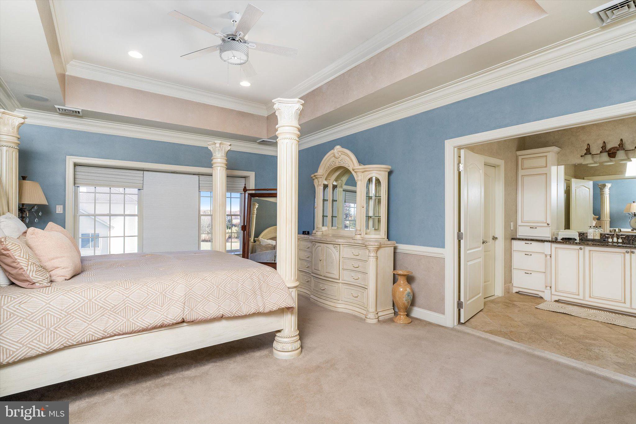 30 Ridgeview Way Allentown, NJ 08501 - Photo 41 of 57 a bedroom with a large bed and a chandelier