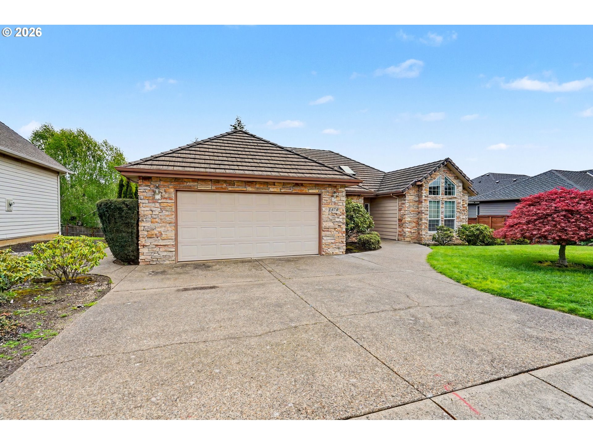 1470 Ranier Loop Northwest Salem, OR 97304 - Photo 3 of 48 a front view of a house with a yard and garage