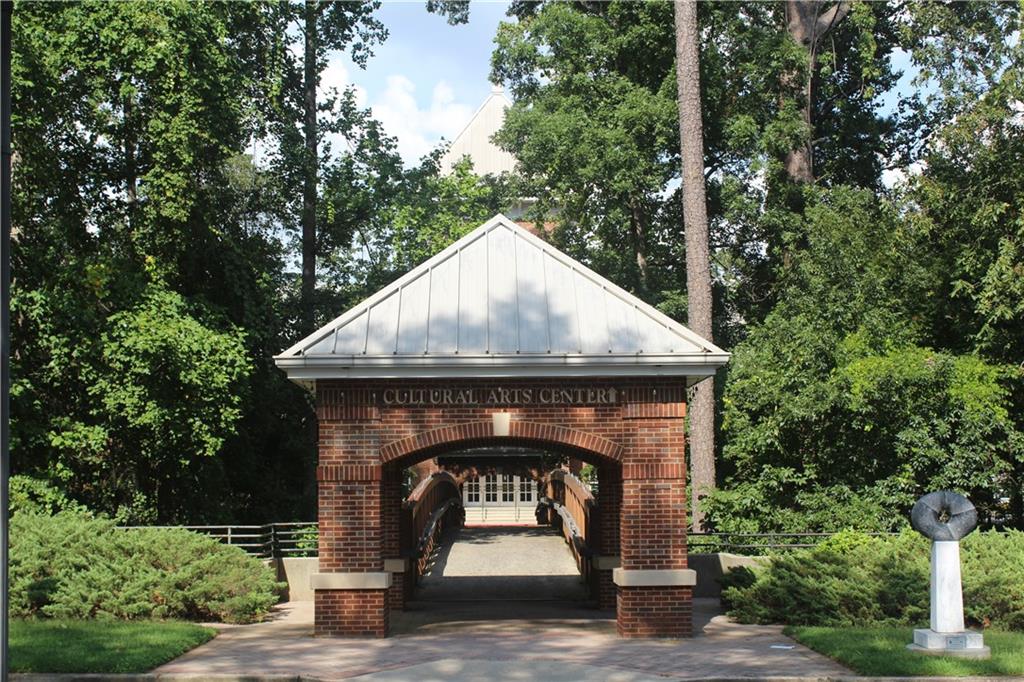 69 Maple Street Roswell, GA 30075 - Photo 12 of 22 a stone house with a small yard
