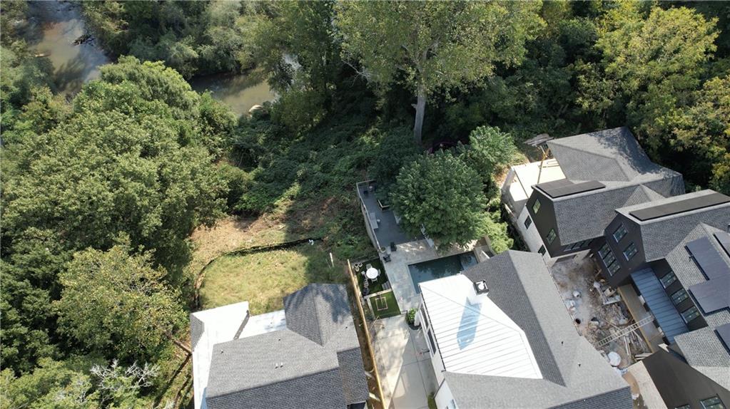 69 Maple Street Roswell, GA 30075 - Photo 18 of 22 an aerial view of a house with outdoor space and trees all around