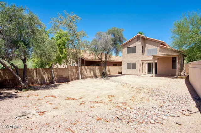 a view of a white house with a yard