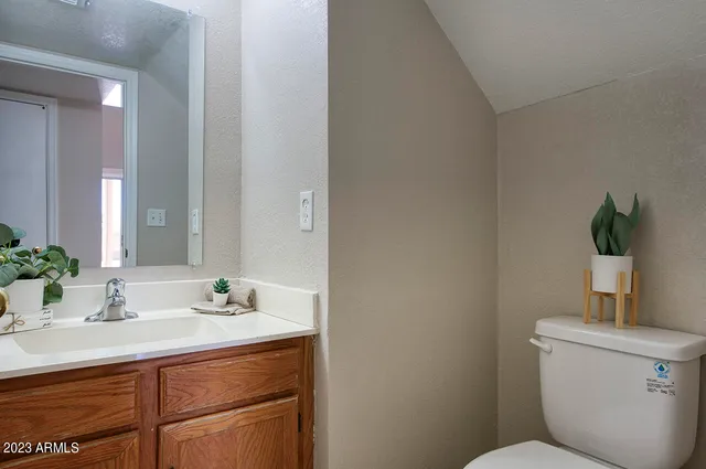 a bathroom with a sink toilet and mirror