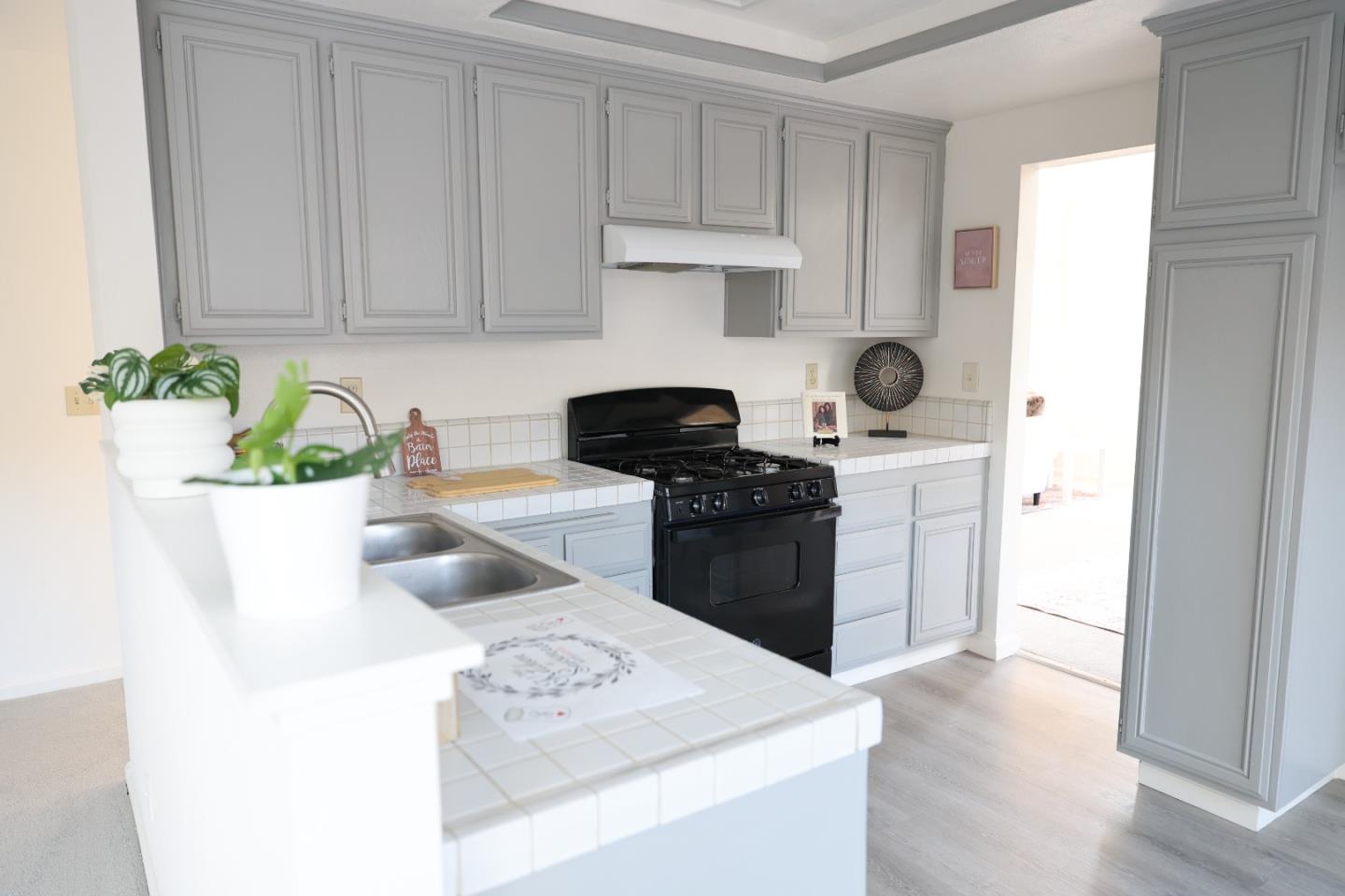 5012 Rodeo Circle Antioch, CA 94531 - Photo 9 of 36 a kitchen with stainless steel appliances a sink a stove a chimney a refrigerator and cabinets