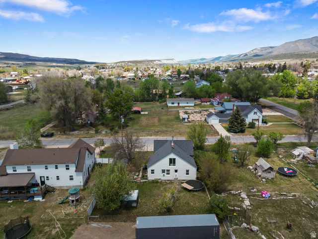 137 West 200 S Street Fairview, UT 84629 - Photo 30 of 34 Aerial perspective showcasing a residential area with a prominent white two-story home featuring a dark roof