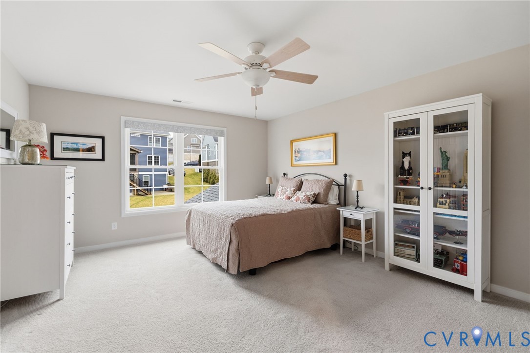 4001 Bircham Loop Midlothian, VA 23113 - Photo 29 of 33 a spacious bedroom with a bed and a chandelier