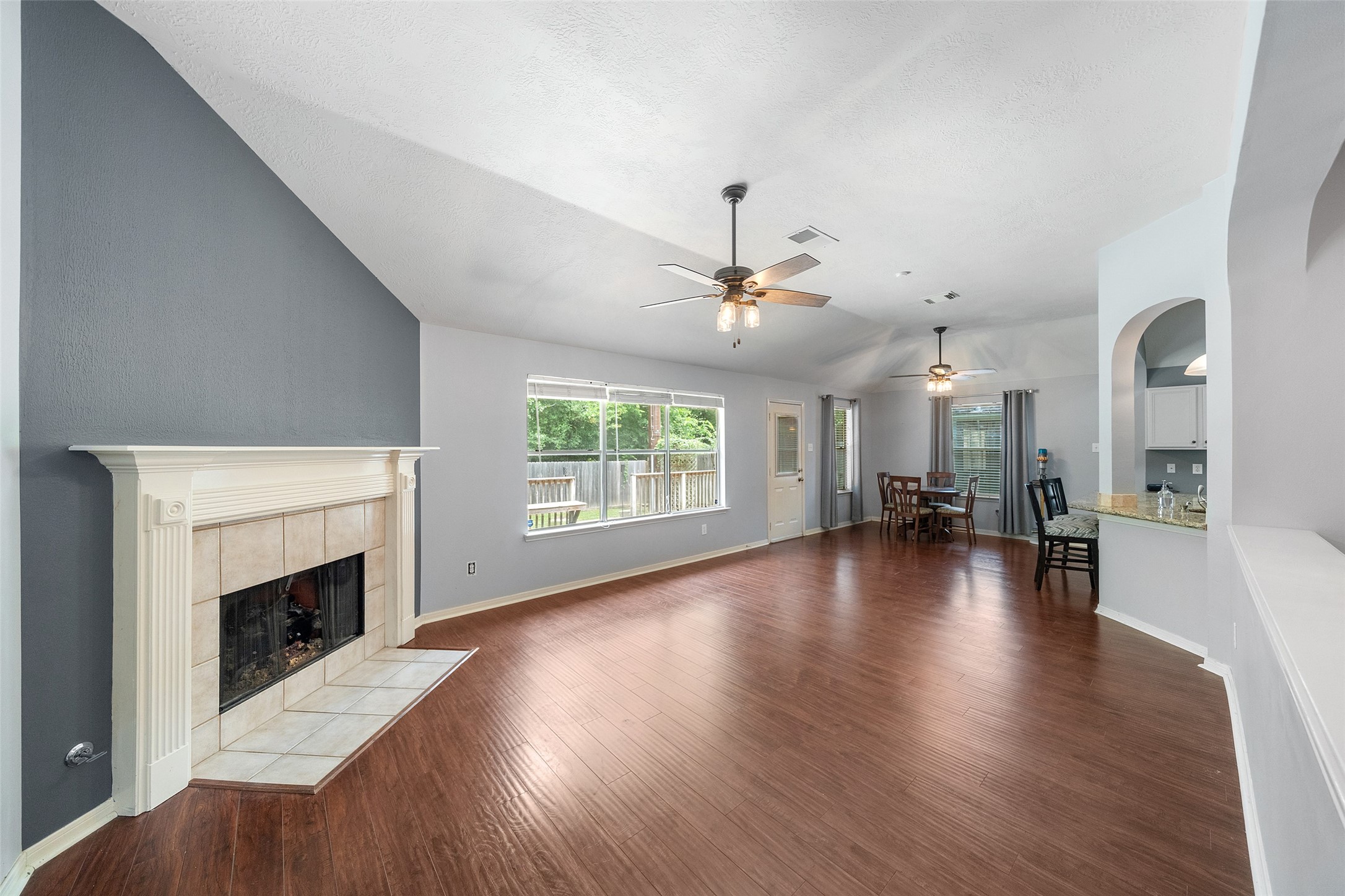 19718 Teller Boulevard Spring, TX 77388 - Photo 9 of 47 an empty room with wooden floor fireplace and windows
