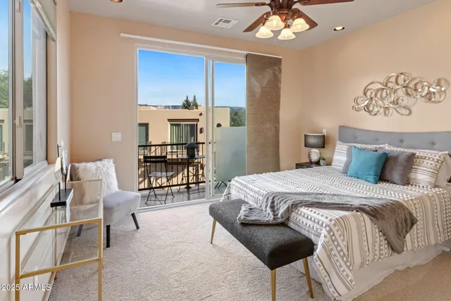 a bedroom with a large bed and a chandelier