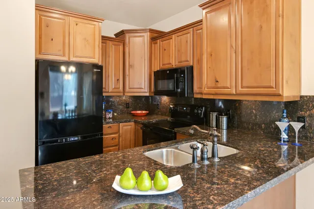 a living room with furniture kitchen and a chandelier