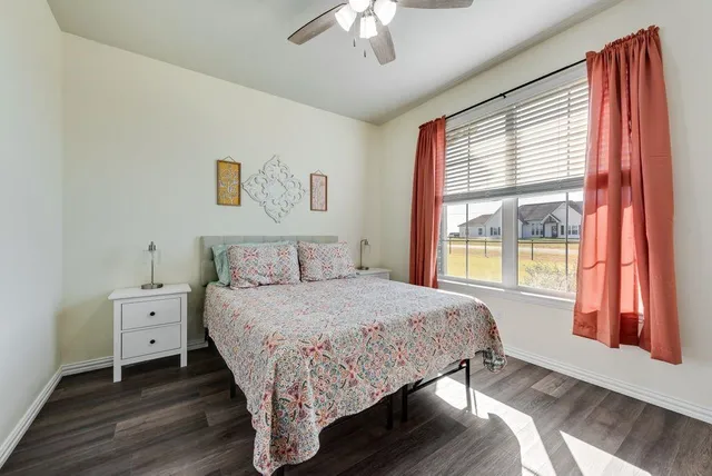 a bedroom with a bed and a large window