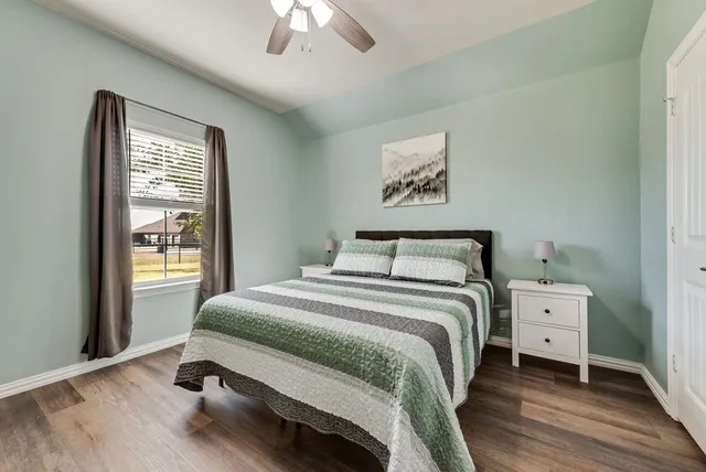 a bedroom with a bed and a window