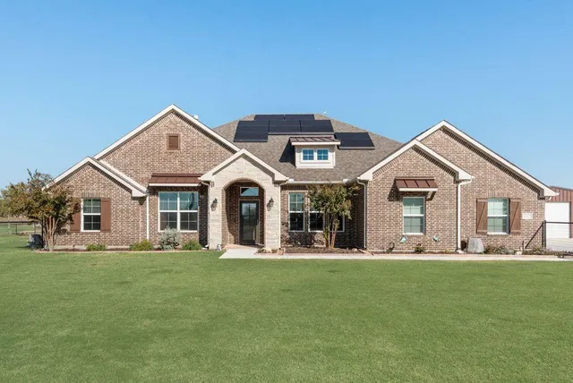 a front view of house with yard and green space