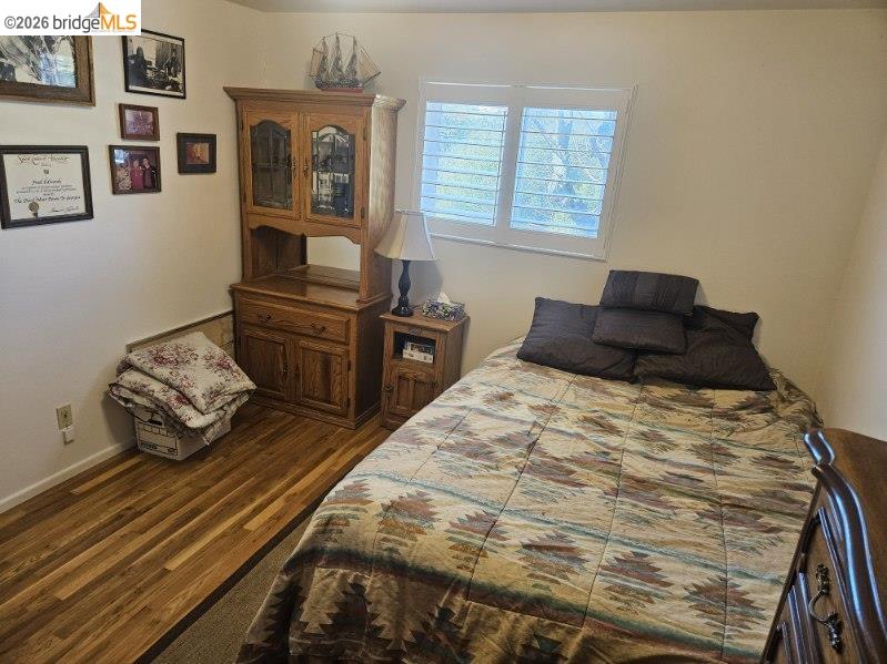19967 Peaceful Oak Road Sonora, CA 95370 - Photo 16 of 35 Bedroom with dark wood-type flooring and baseboards