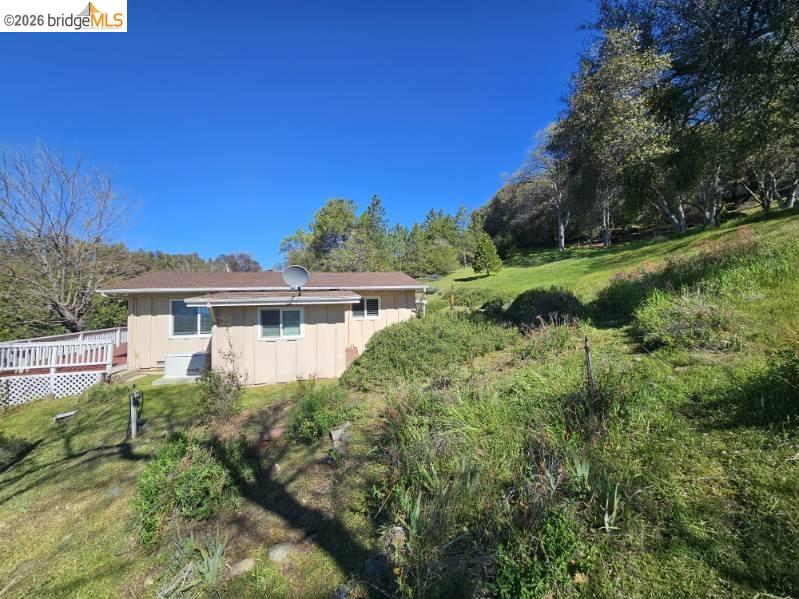 19967 Peaceful Oak Road Sonora, CA 95370 - Photo 28 of 35 Back of house featuring a yard