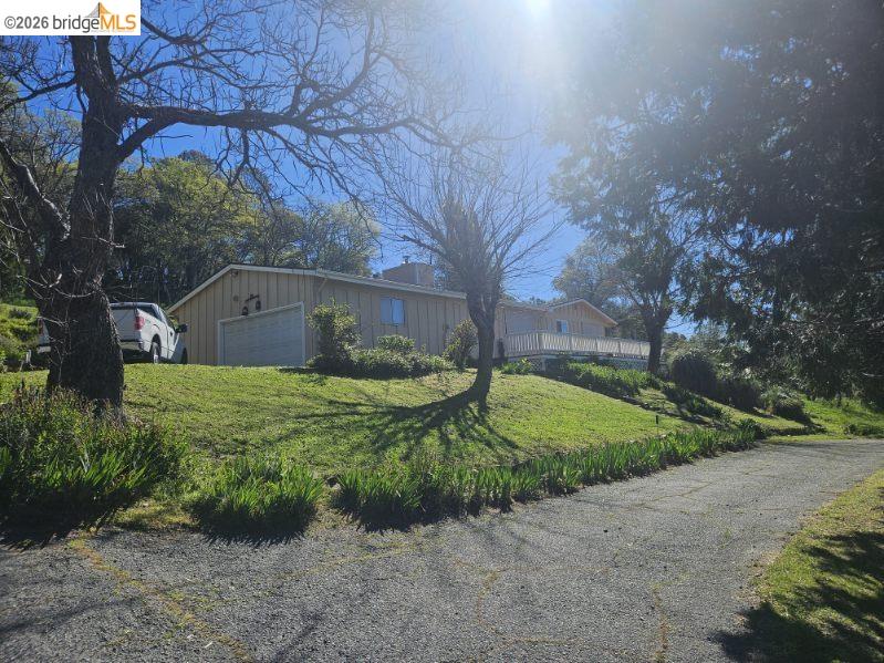 19967 Peaceful Oak Road Sonora, CA 95370 - Photo 3 of 35 View of front facade with a front yard, board and batten siding, and an outdoor structure