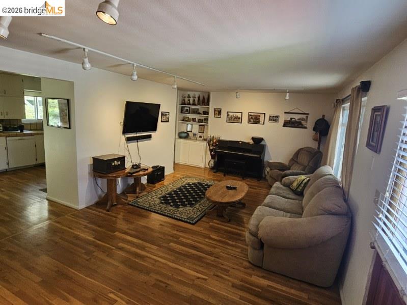 19967 Peaceful Oak Road Sonora, CA 95370 - Photo 4 of 35 Living area with rail lighting and dark wood-style floors